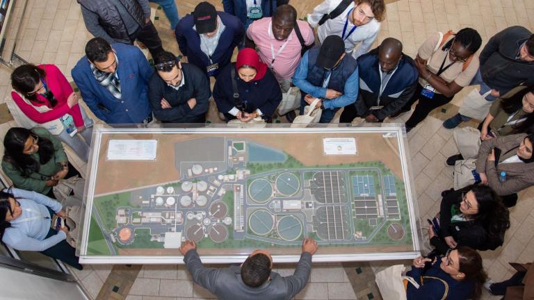 vista aérea de un grupo observando la maqueta de una ciudad