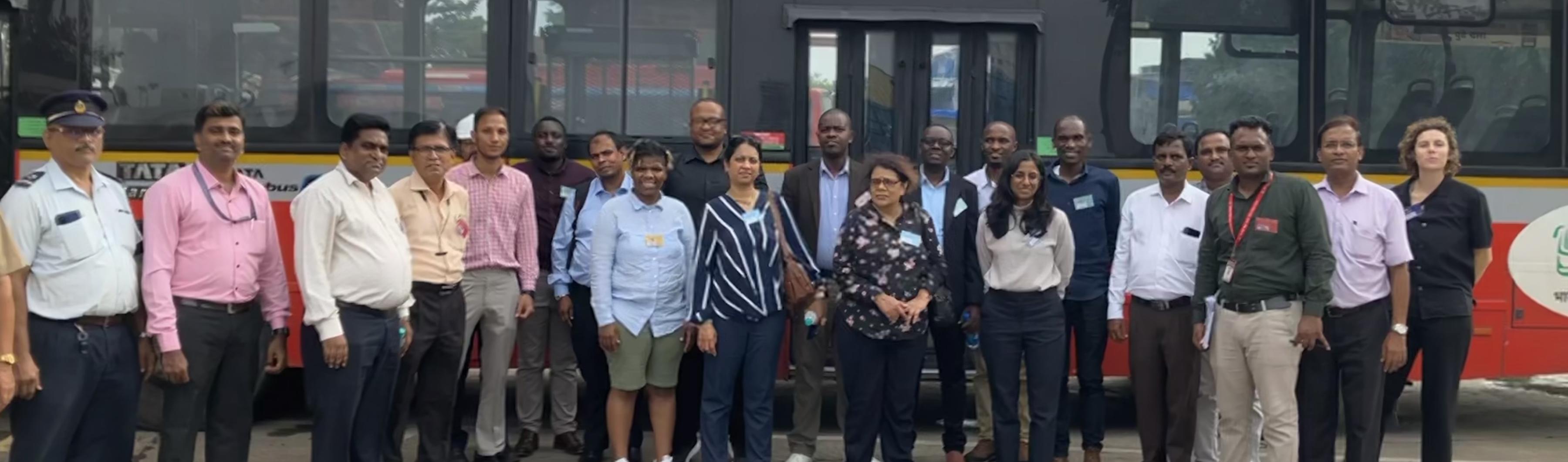 Los participantes en el intercambio Peer to Peer de UrbanShift frente a un autobús de emisiones cero en Bombay.