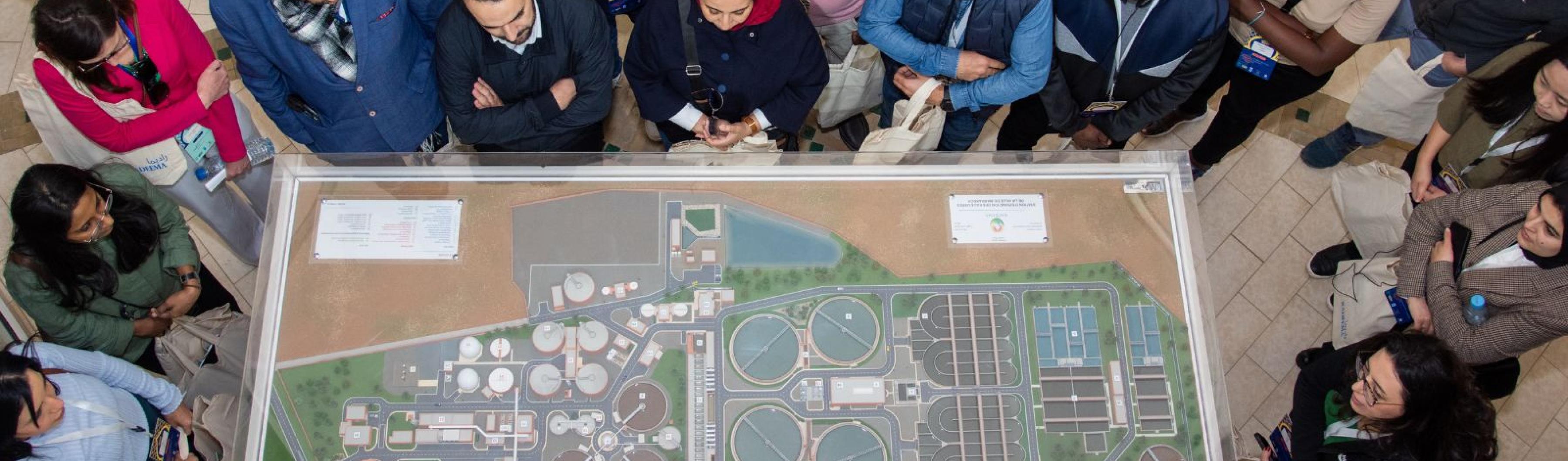 an aerial view of a group looking at a model of a city
